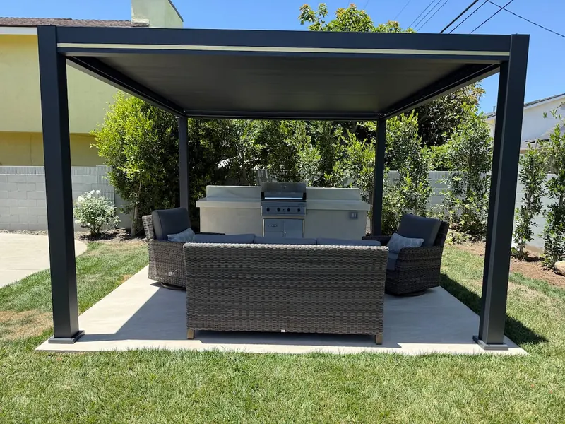 Louvered pergola with lounge seating and the BBQ island